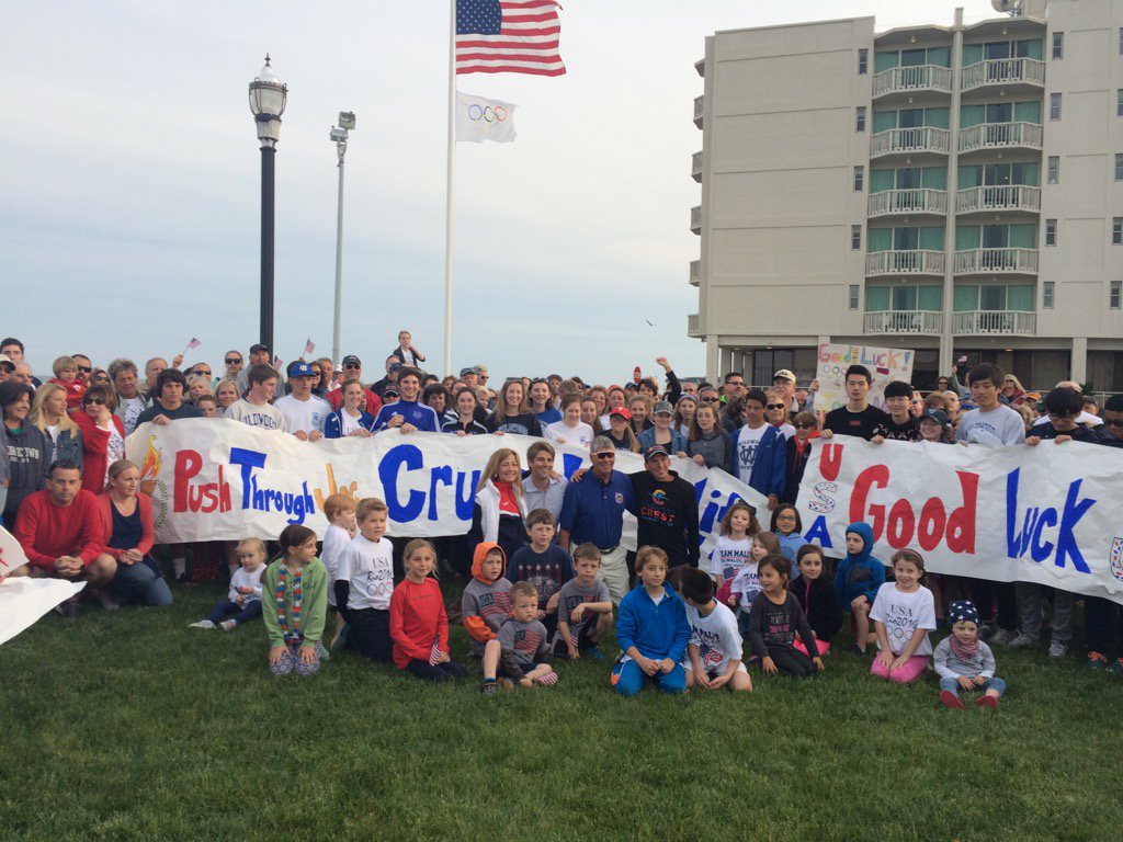 DaveWeinberg19's tweet photo. Wildwood Crest native @joetriathlon (black shirt) and his family pose under the Olympic flag. #RoadToRio https://t.co/J9WpWxcFT8