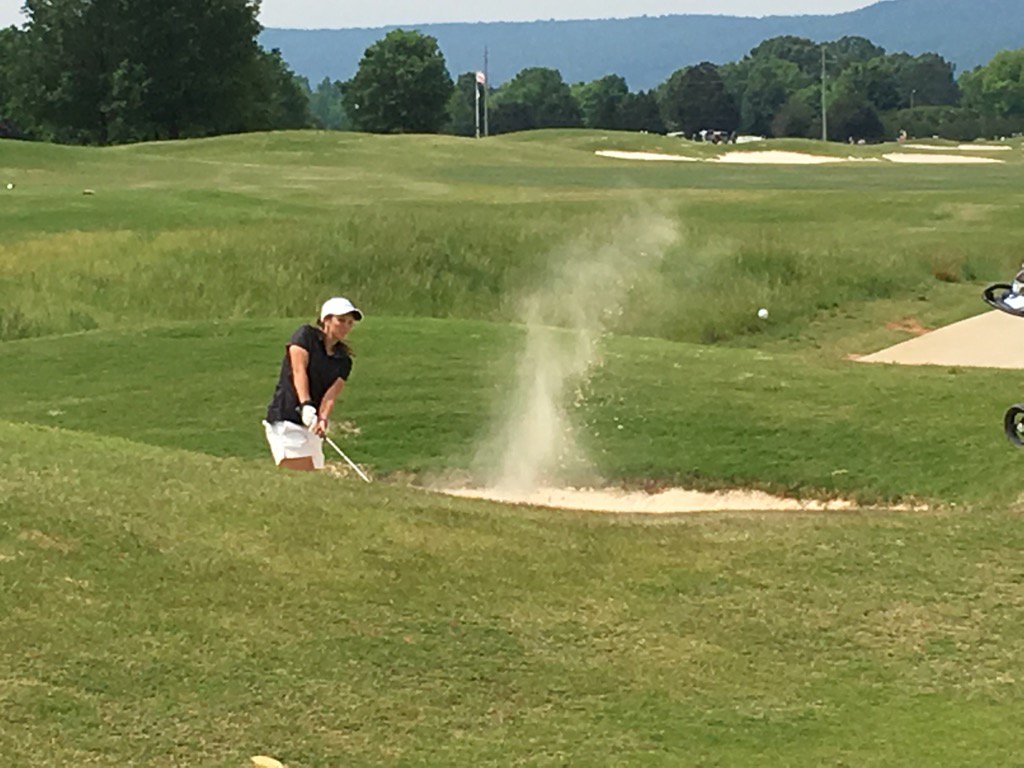 White Plains' county champ Layne Dyar blasts out of bunker on 11 in state tourney at Hampton Cove Highlands today.