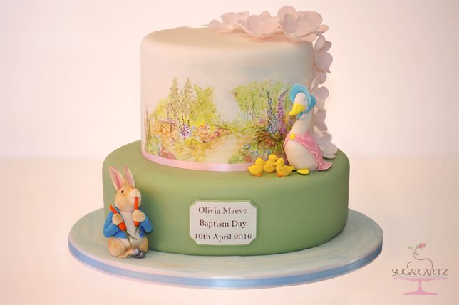 SugarArtz's tweet photo. We created this two tier hand-painted #BeatrixPotter themed Baptism cake with #PeterRabbit and #JemimaPuddle Duck. https://t.co/hvR3p194Kq