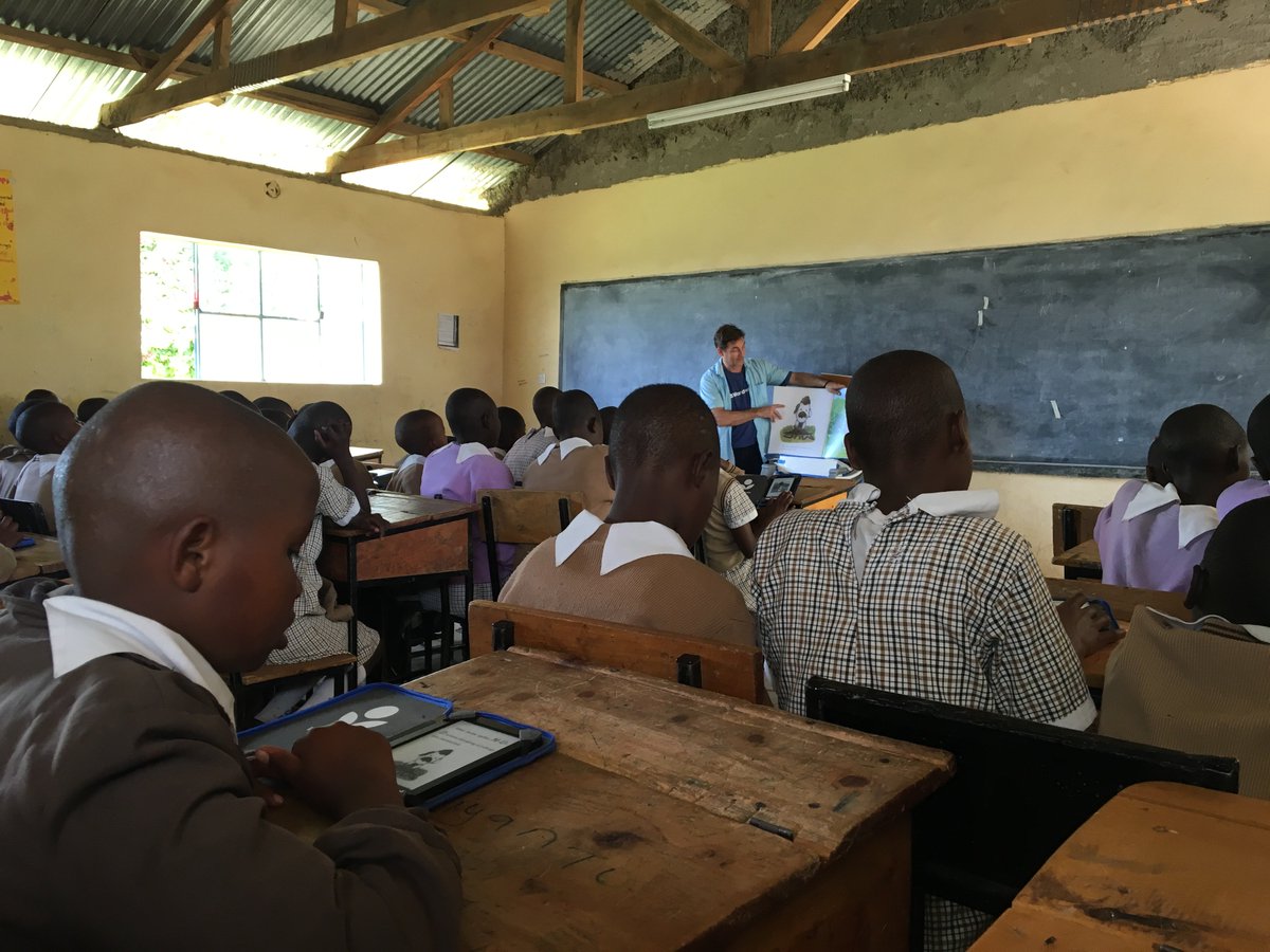 NanceyBee's tweet photo. @tadhills reading Rocket Learns to Read while girls follow along on their e-readers! @worldreaders @penguinrandom https://t.co/EmamXGHM5p