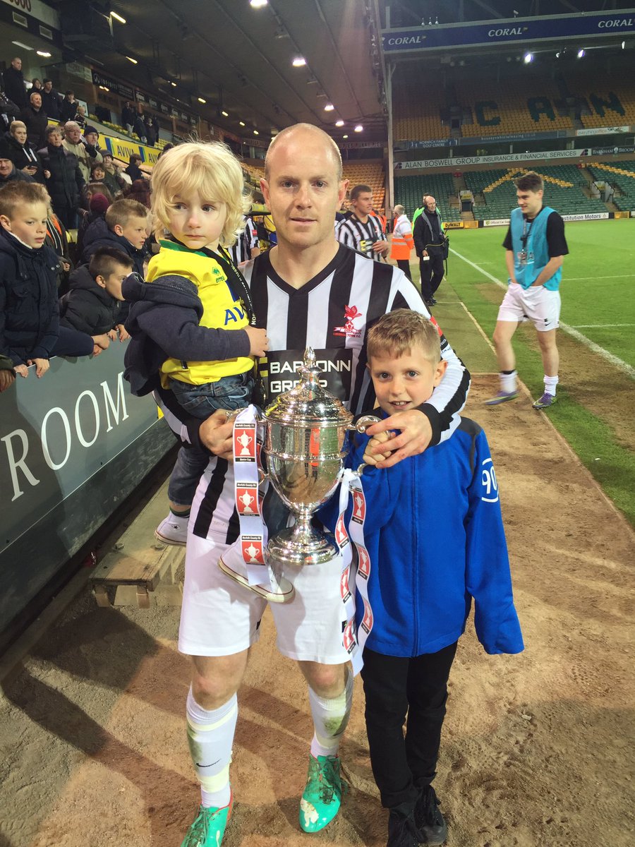 NorfolkCountyFA's tweet photo. Goalscorer and @derehamtown striker @luketut with the Senior Cup trophy #NorfolkFootball https://t.co/UcUZlSp8Cl