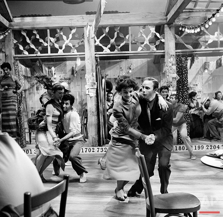 Actress Jean Simmons dances with actor Marlon Brando in a scene for