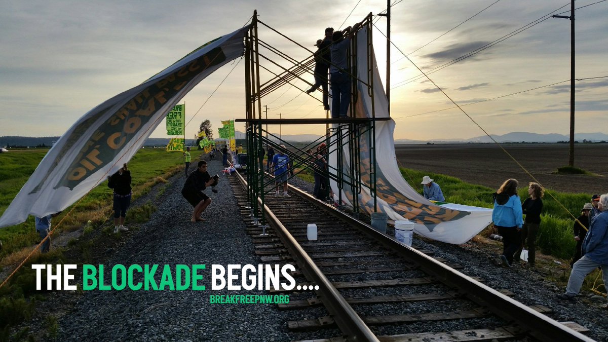 BreakFreePnw's tweet photo. 150+ protesters are locked to our standing on the tracks blocking all oil train traffic #breakfreepnw #breakfree2016 https://t.co/Q6nZexCd7Z