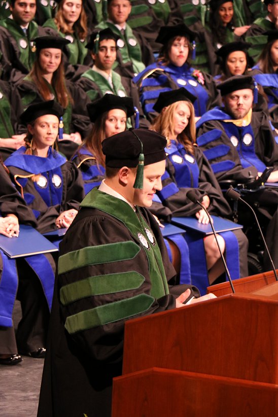 MayoClinicSOM's tweet photo. Joe delivers his address while his classmates giggle behind him. #MayoGrad https://t.co/2UdzWqWzOj
