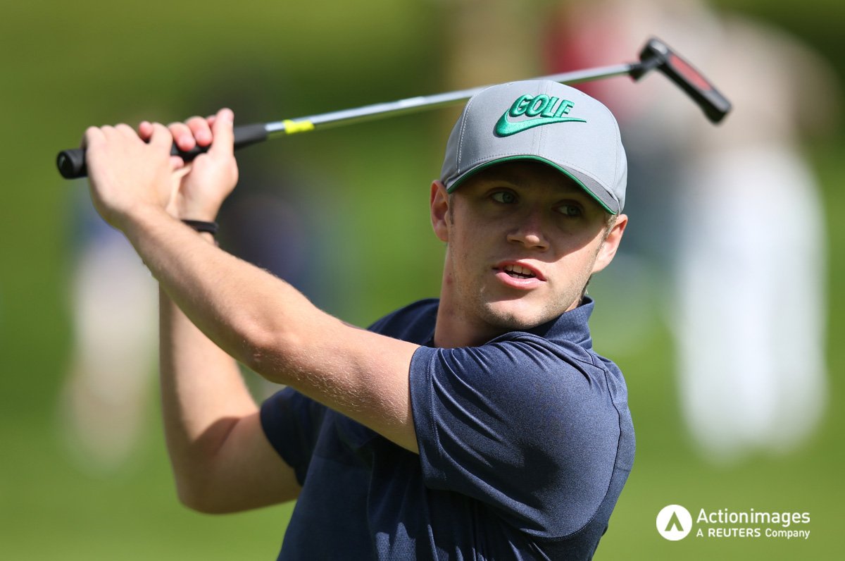 ActionImages's tweet image. Niall Horan plays a shot during the Pro-AM at the #IrishOpen #OneDirection @paulmjchilds