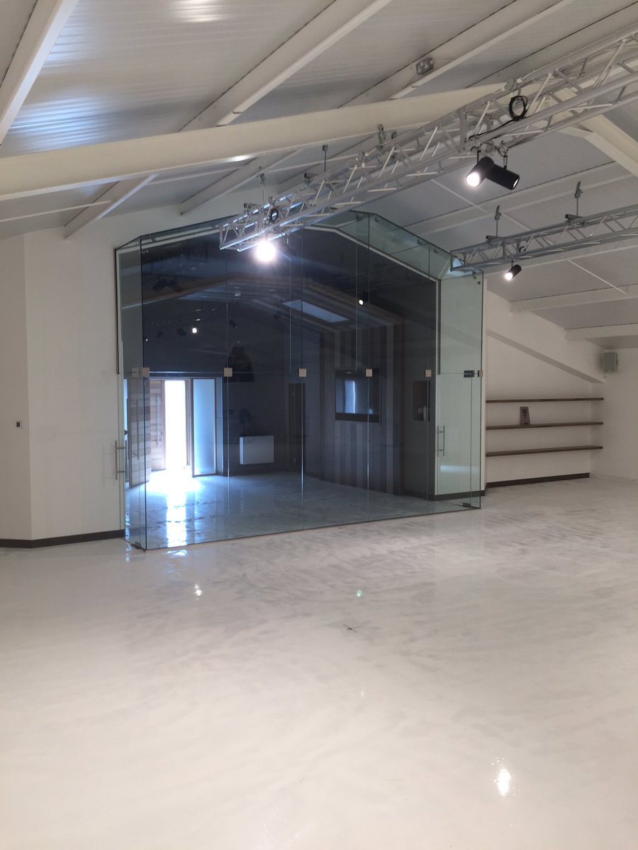 A glass frontage we fitted in a building to encapsulate a boardroom/lounge in a clients garage to view his cars.