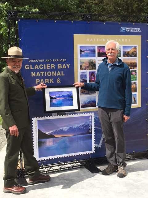 USPS's tweet photo. #NPSstamps in Alaska: @GlacierNPS Supt Philip Hooge withTom Bean, photographer for the new #USPSstamp #FIndYourPark https://t.co/haauiAYkLu