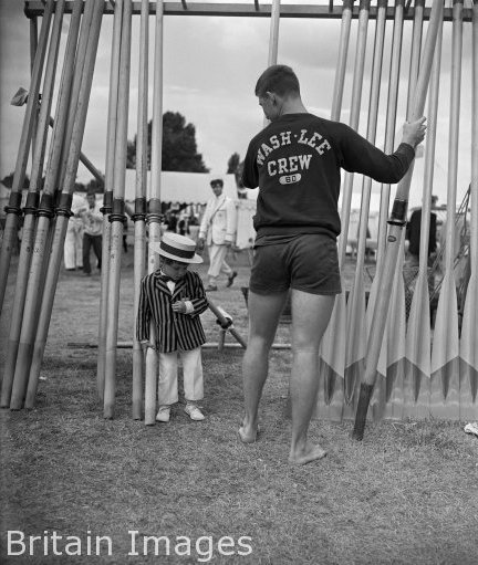 BritainImages's tweet photo. A boy in a straw boater &amp; blazer is dwarfed by Wes Coker of the Washington Lee Crew https://t.co/DIfiwK6qFn #rowing https://t.co/VPxe1cvxeD