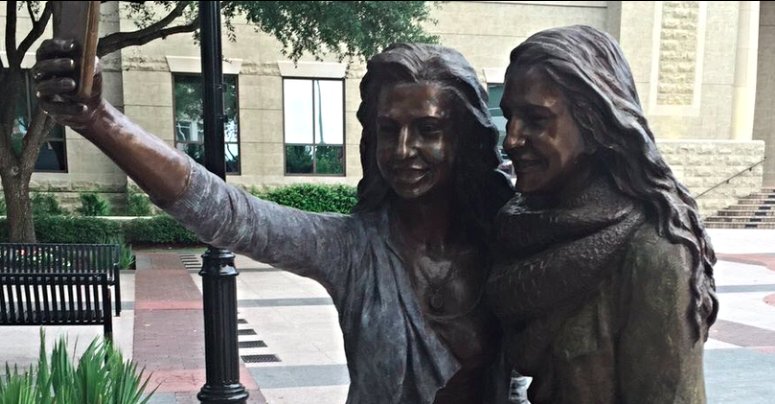 austin360's tweet photo. Sugar Land town hall now has a statue of two girls taking a selfie https://t.co/uA8xEDiLTx https://t.co/nIvkCl6SvD