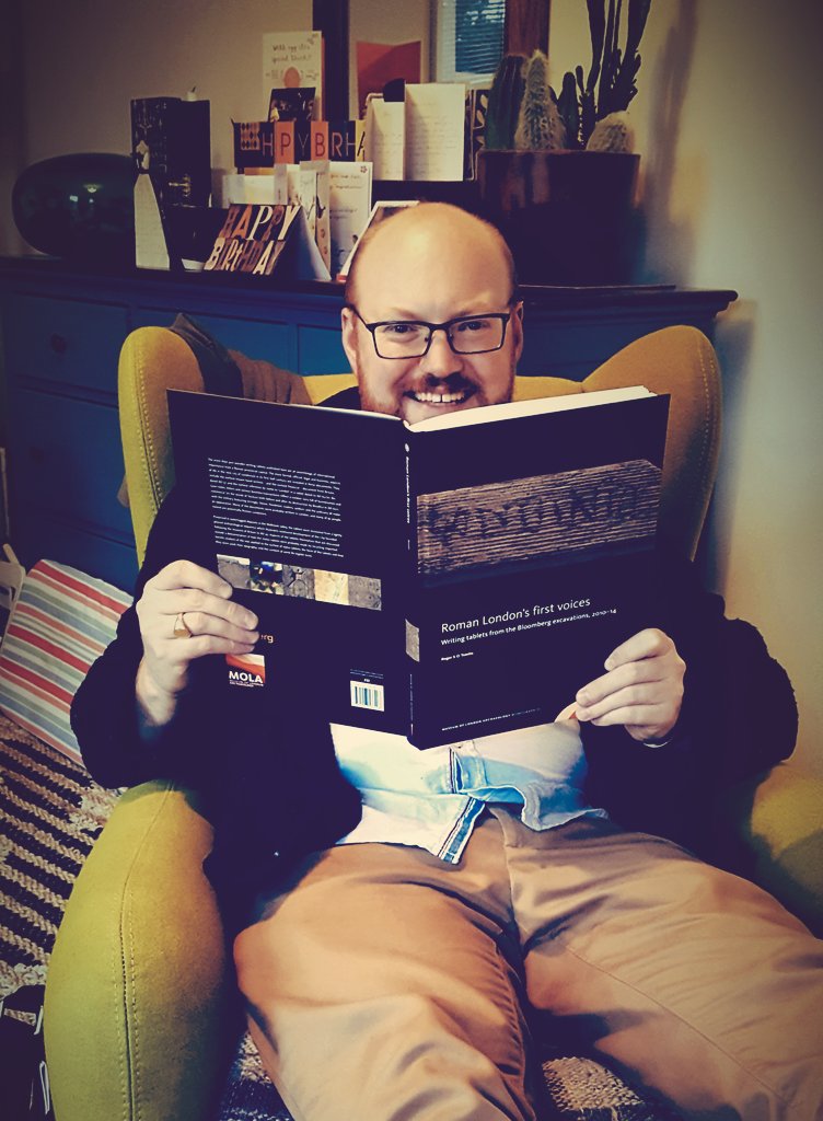 ArchaeoKath's tweet photo. @mola someone's a happy boy with his new book. @GlynnJCDavis #londinio #writingtablets #archaeology https://t.co/mGrTu6tzyA