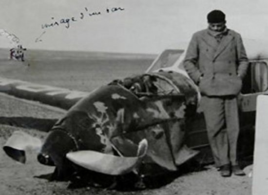 Antoine de saint-exupéry standing next to his plane 