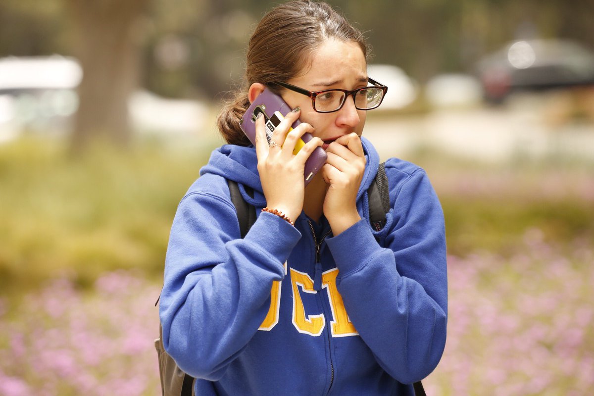 Gabriela Romero calls her mom as students are released on UCLA campus after two people were shot and killed Wednesday. (Al Seib / Los Angeles Times) Gabriela Romero calls her mom as students are released on UCLA campus after two people were shot and killed Wednesday. (Al Seib / Los Angeles Times)