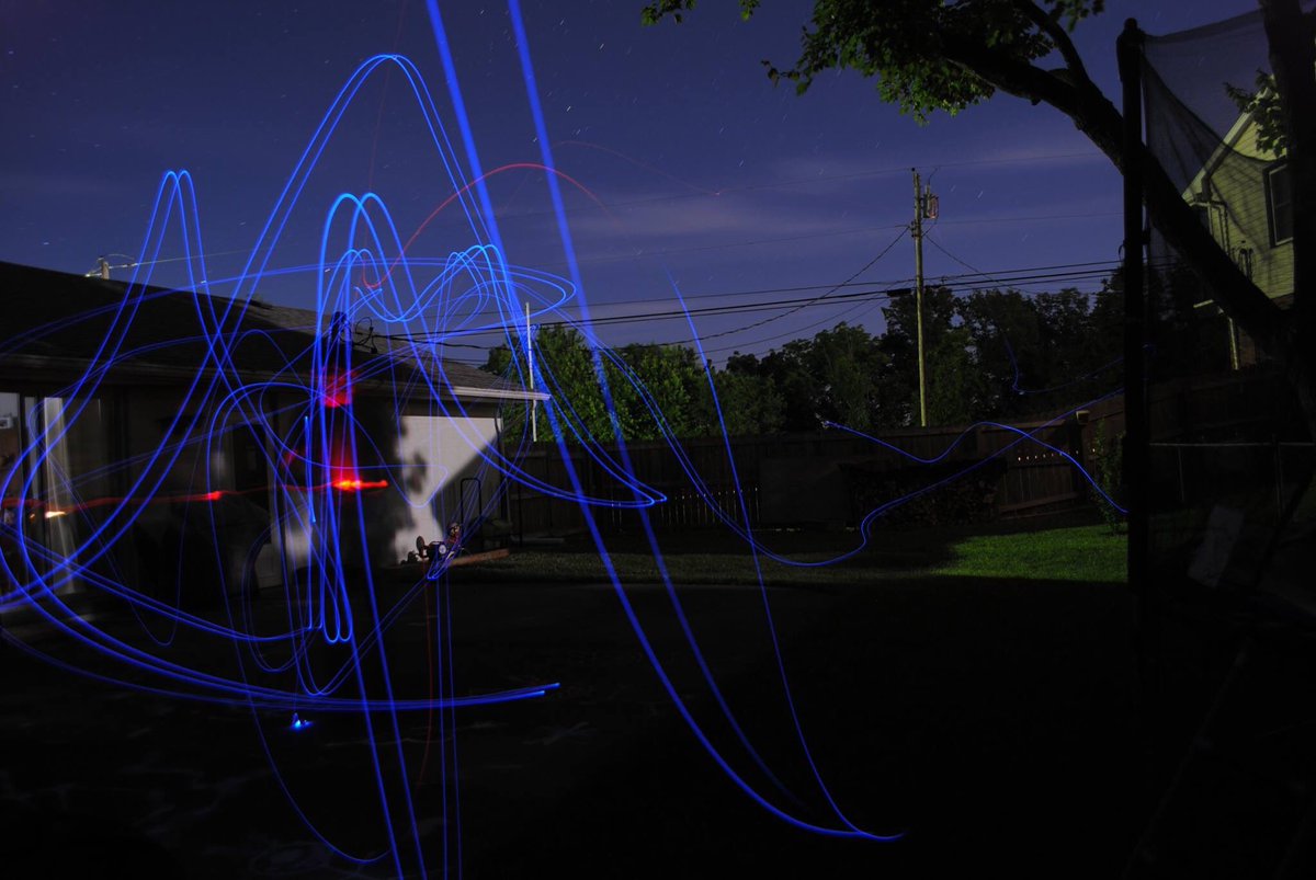 Long exposure view of mini drone flight in the dark