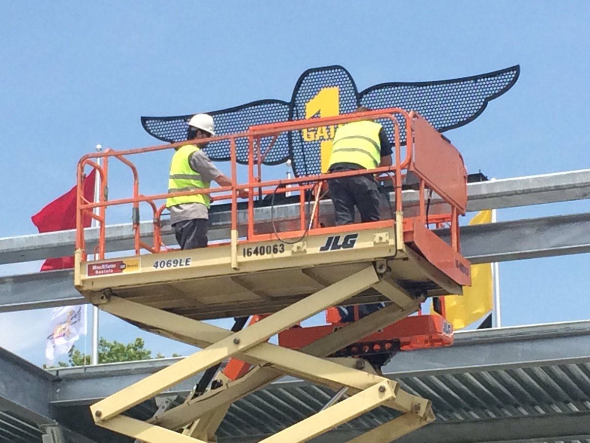 susanbatt's tweet photo. It's almost time!!! Installing the #WingandWheel logo over @IMS main gate. #readytorace #indy500 #wthr https://t.co/kgADK9492o