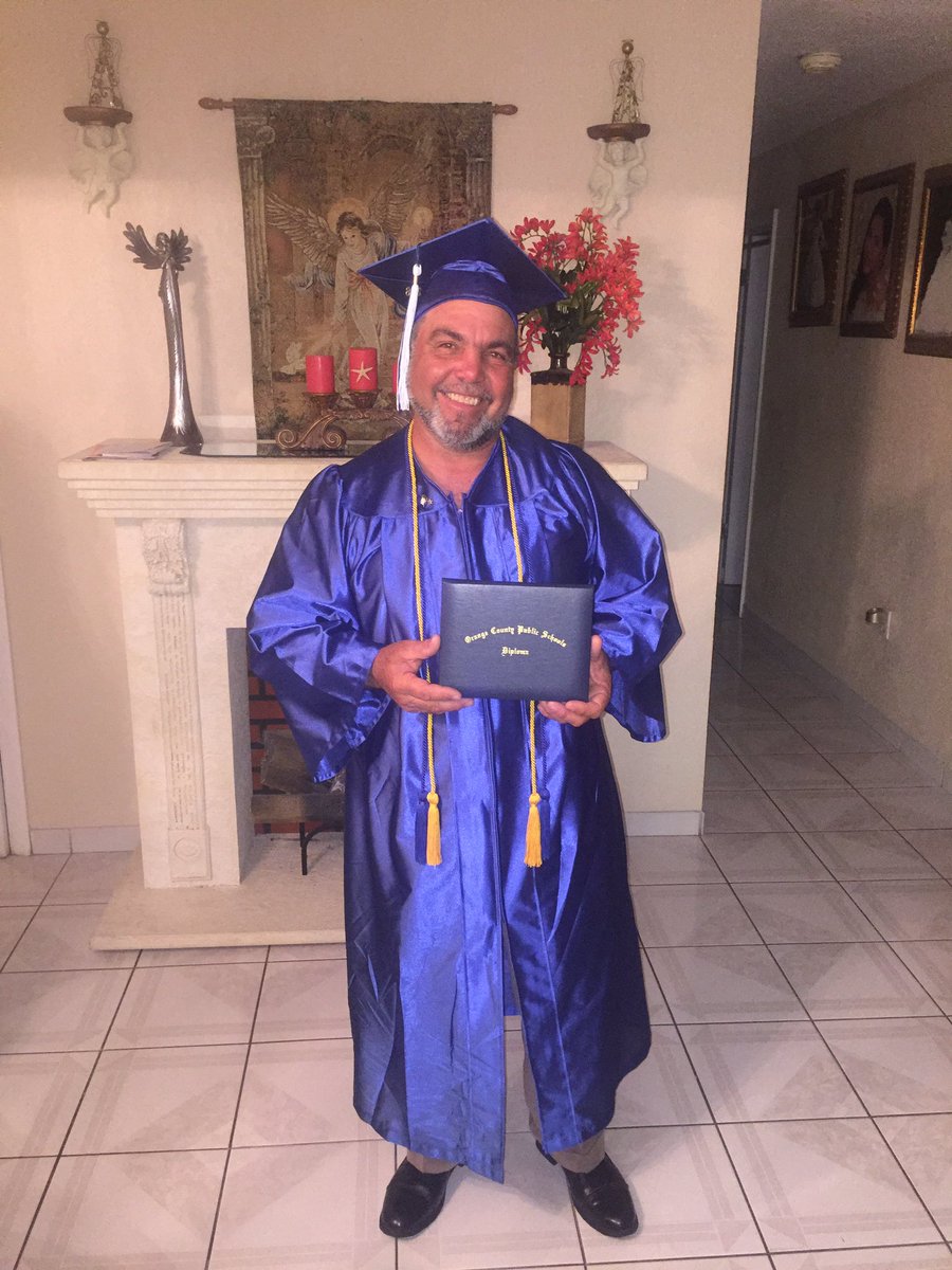 My dad didn't get to graduate in Cuba, so he asked he could wear my cap and gown to see how it feels