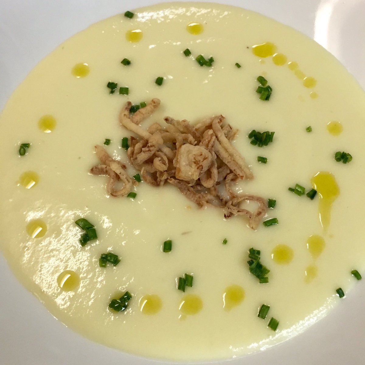 A chilled soup on a warm day!  Potato &amp; leek soup finished with chives, crispy shallots &amp; extra-virgin olive oil