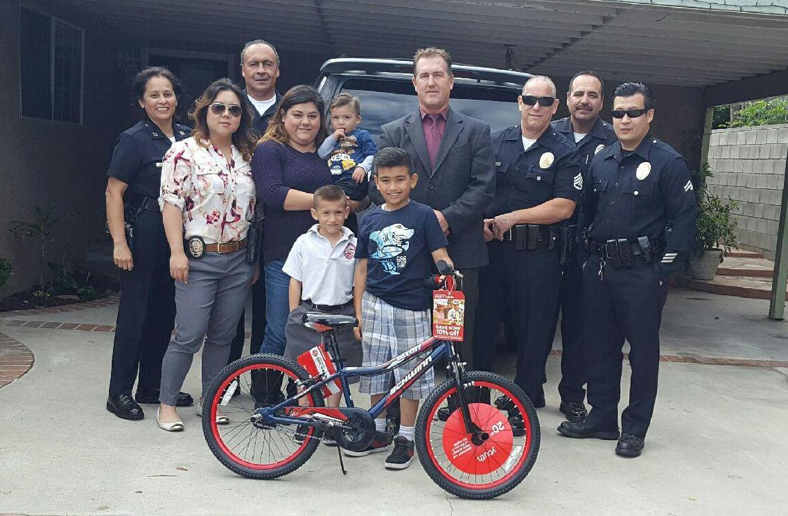 LAPDHQ's tweet photo. #LAPD Foothill Detectives join together with #Target helping 8-yr old boy to ride again after theft of his bike. https://t.co/vXQWn0pvJP