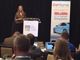 CarGurusDealers's tweet photo. Google's @KellyMcN (and a CG banner) on stage at @pcgdigital #DMSC2016 this week. One of many great DMSC talks! https://t.co/QGW2cPvwJQ
