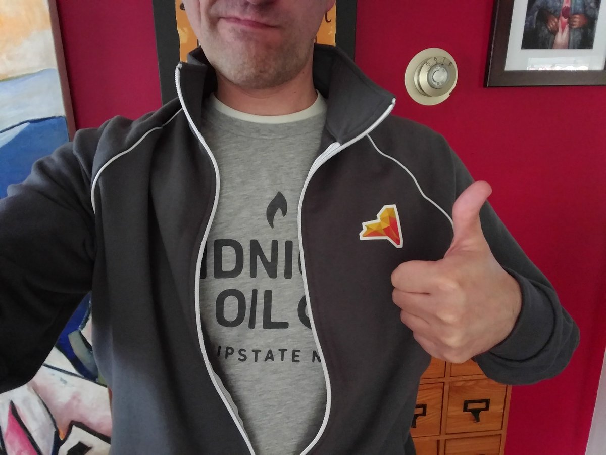 Photo of me giving a thumbs-up at the camera. I am wearing my #CreateUpstate zip-up and my #CreateUpstate t-shirt. I am not smiling.