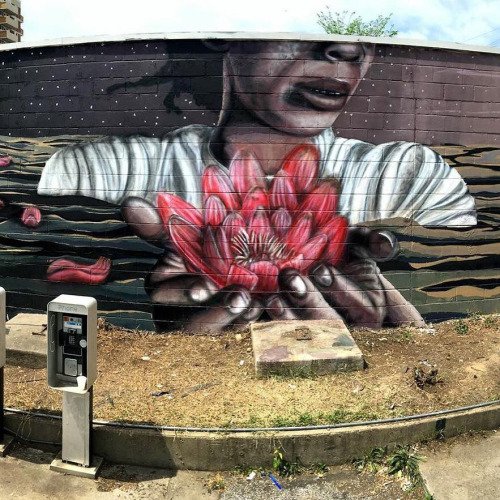 A woman stands in water, half submerge... streetsy.com/post/145073333… #streetart #graffiti | twibble.io