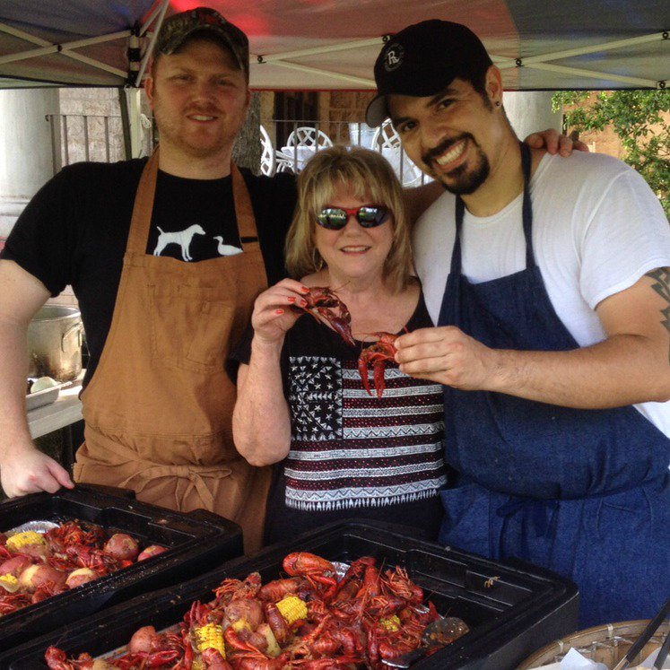 Chef Tyler, Carrie Wilson and chef Andre at the Riverhill crawfish boil. Carrie gives her Cajun seal of approval