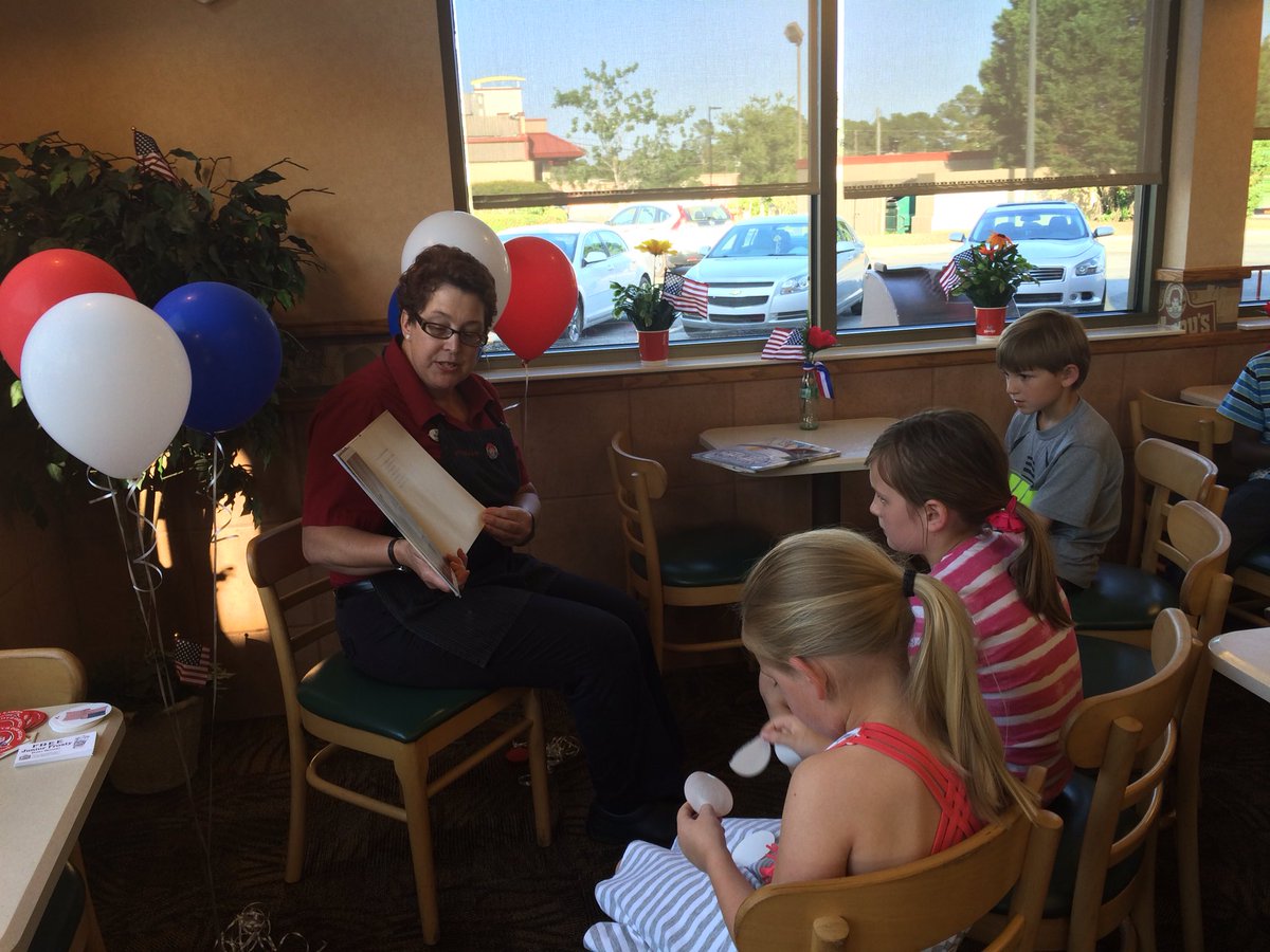 A manager at the Wendy's in Tifton reads to children "America's White Table" about the meaning of Memorial Day.