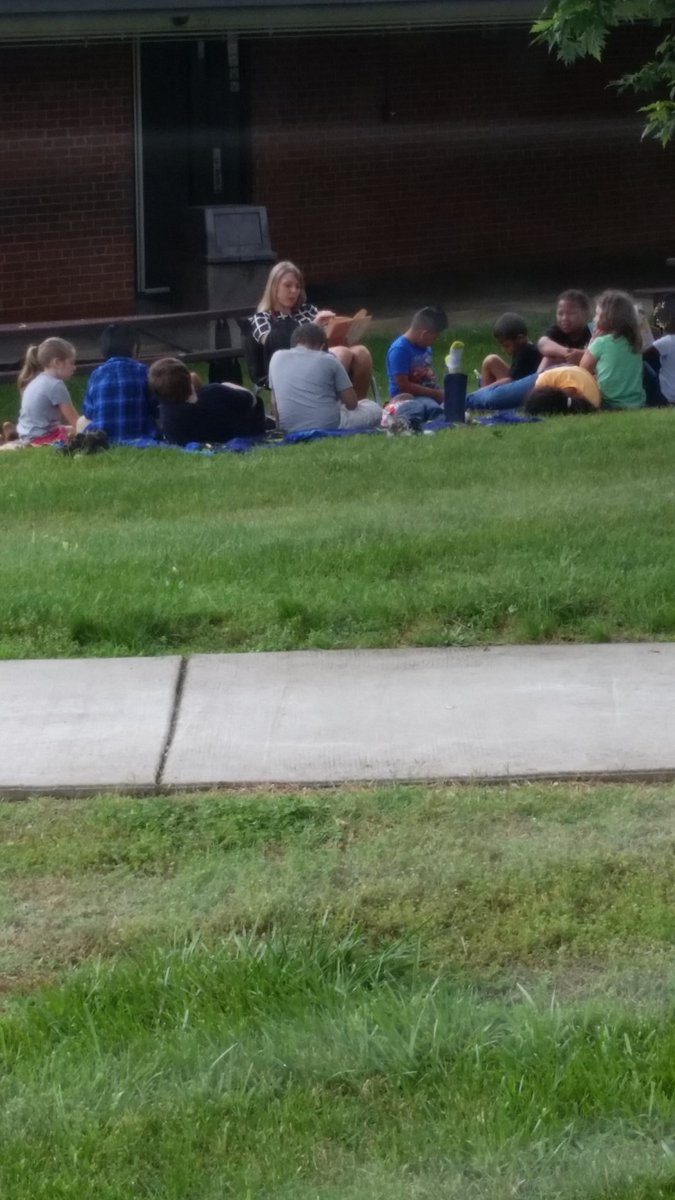 1st graders <a href="/FalconsFES/">FranklintonElemSch</a> enjoying a book together outside.