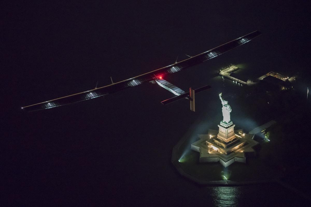 SunPower's tweet photo. #ICYMI: Solar Impulse 2, plane flying 'round the world w/ @SunPower #solar, flew by the Statue of Liberty in #NY. https://t.co/V22WPA1iWk