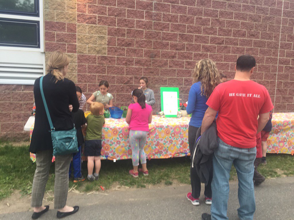 Planting cucumbers after the story walk at Title I Family Night.