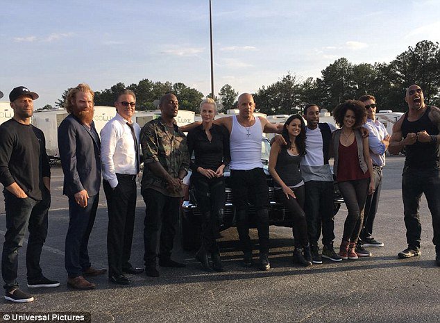 DailyMailCeleb's tweet photo. Charlize Theron and Michelle Rodriguez make a Vin Diesel sandwic in Furious 8 cast shot https://t.co/TsFMmebAkc https://t.co/T9LMgwFWsu
