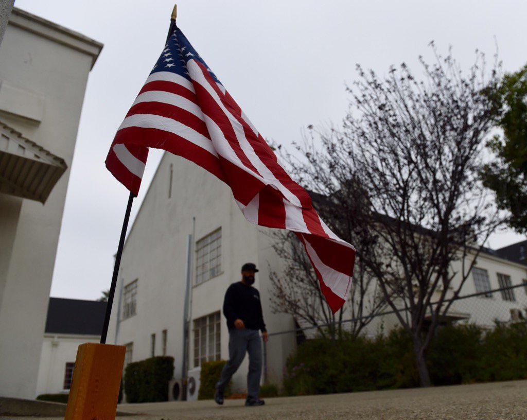 JCMaherPhoto's tweet photo. An American Flag waves outside the polling place at First United Methodist Church in Ontario. #IEVote https://t.co/klGtbuoYI2