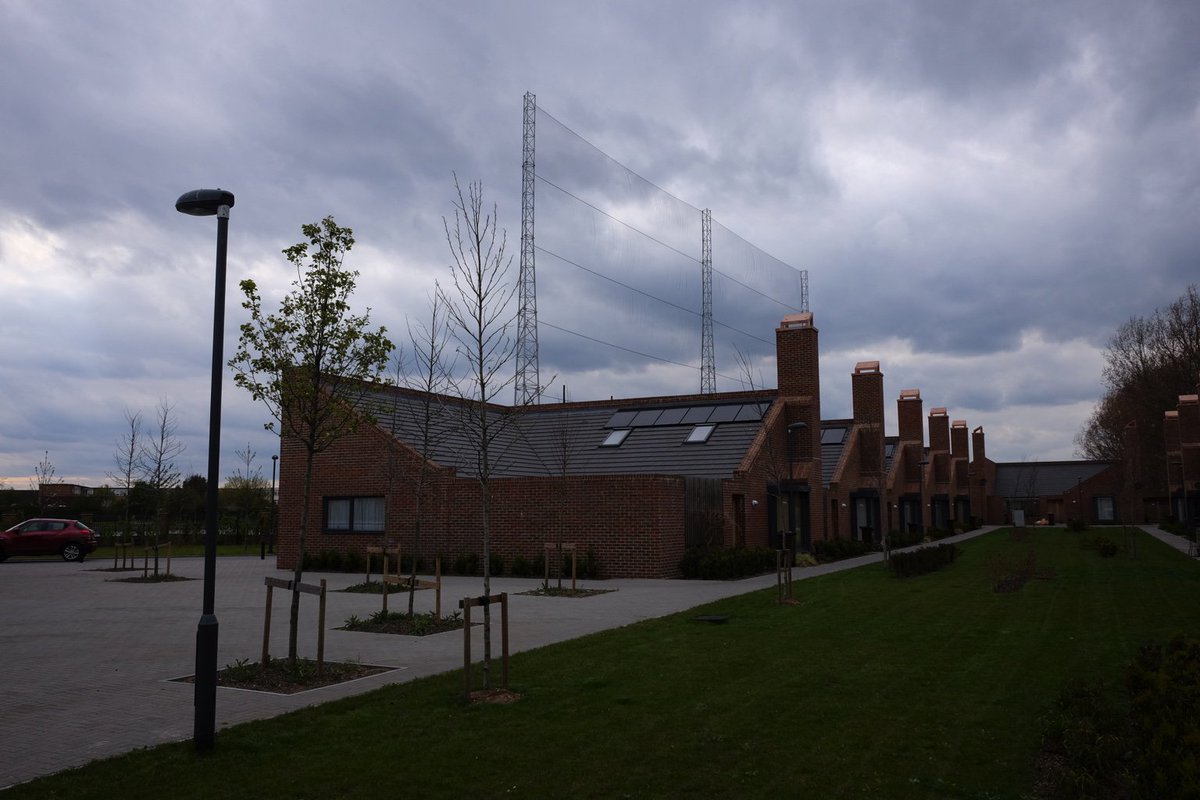 Courtyard houses in Thurrock by driving range need net to screen wild shots. #HDAwards judges found loads on visits