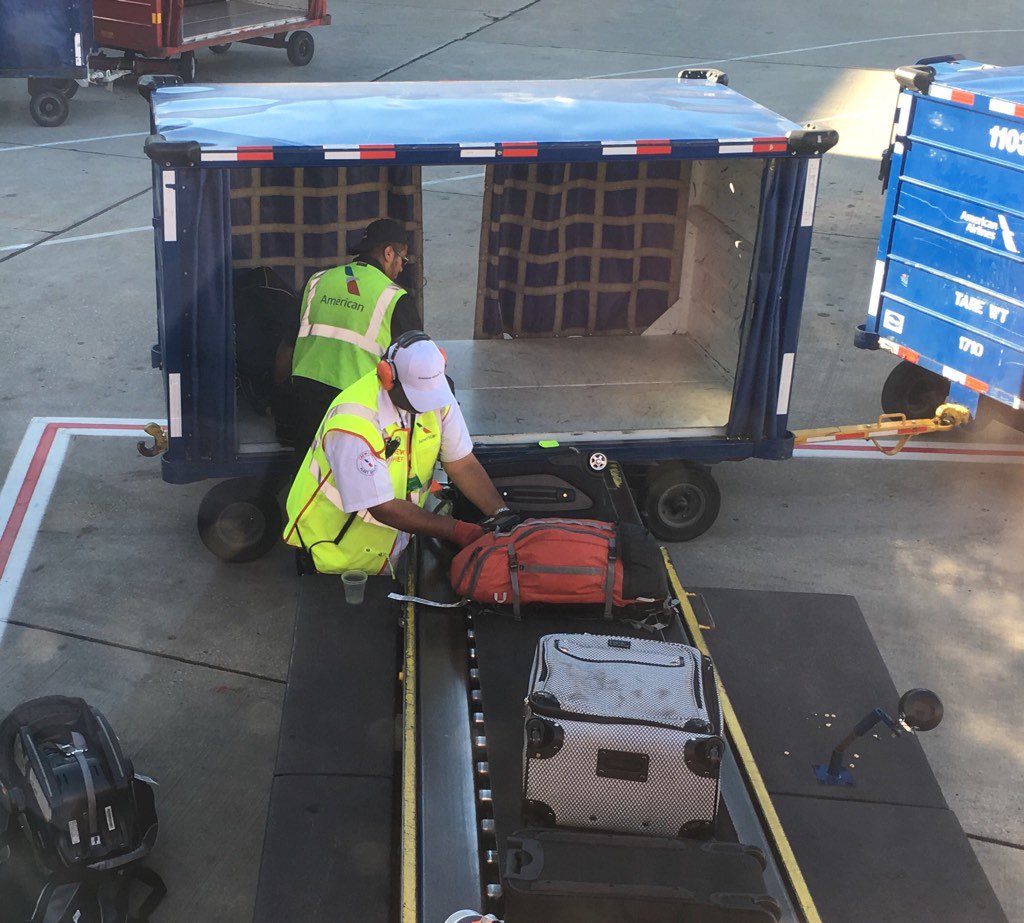 TroyWitt's tweet photo. @AmericanAir kudos to this baggage crew who I just saw closing the zippers on bags during loading. AA2338 Ord-sna 👍🏻 https://t.co/Z6W96vSE0N