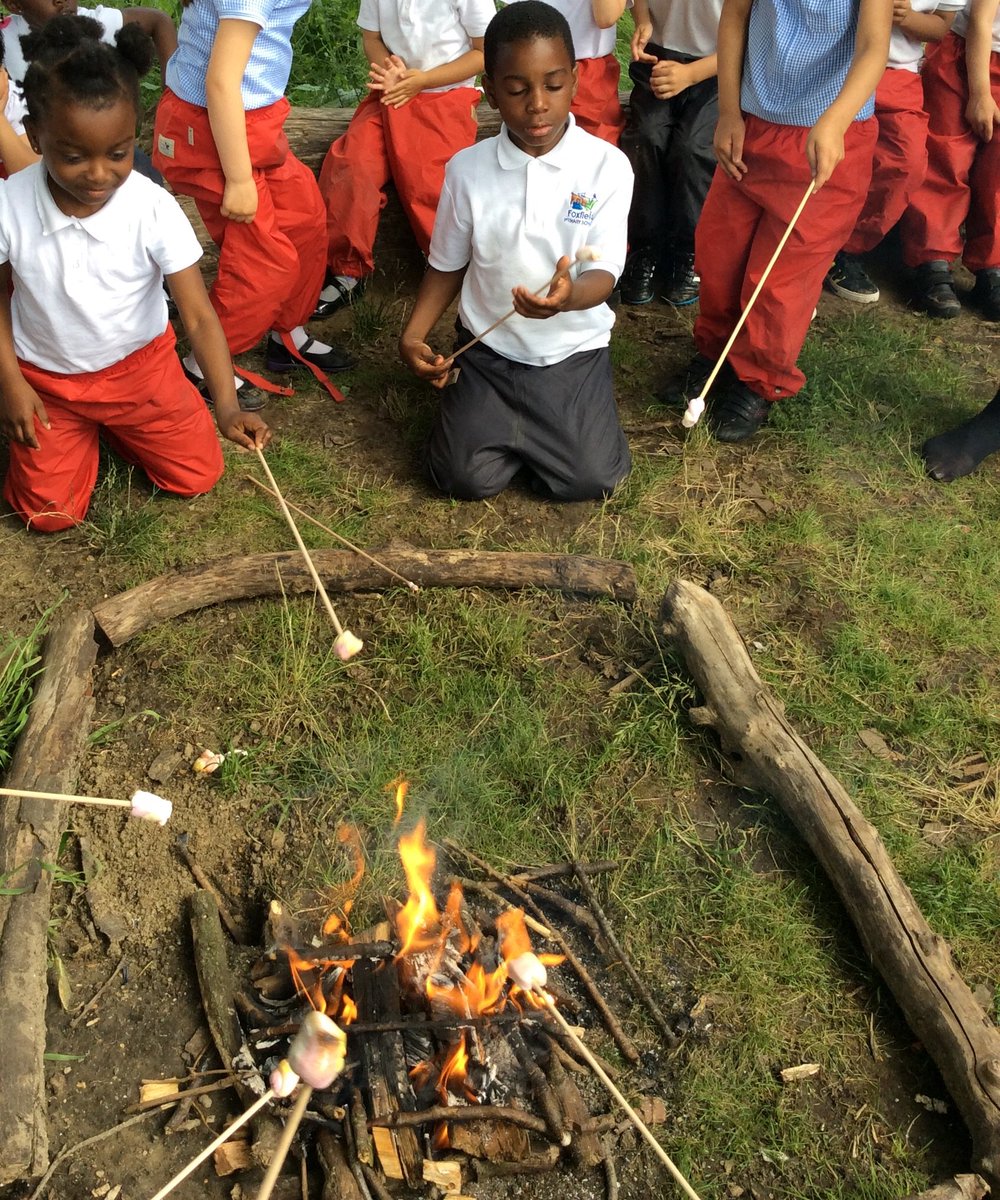 Toasting marshmallows on a real campfire in reception