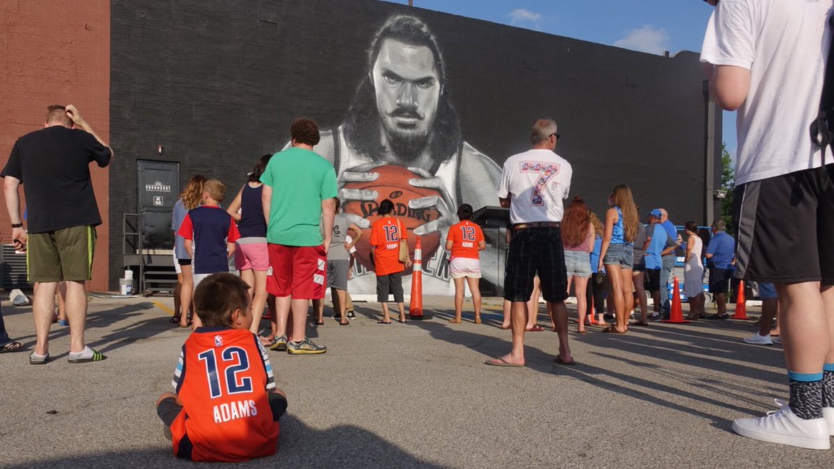 okcthunder's tweet photo. Already larger than life, Steven Adams gets even larger as NZ artist Graham Hoete (MrG) completes his mural in OKC! https://t.co/oMs8wa8sYw