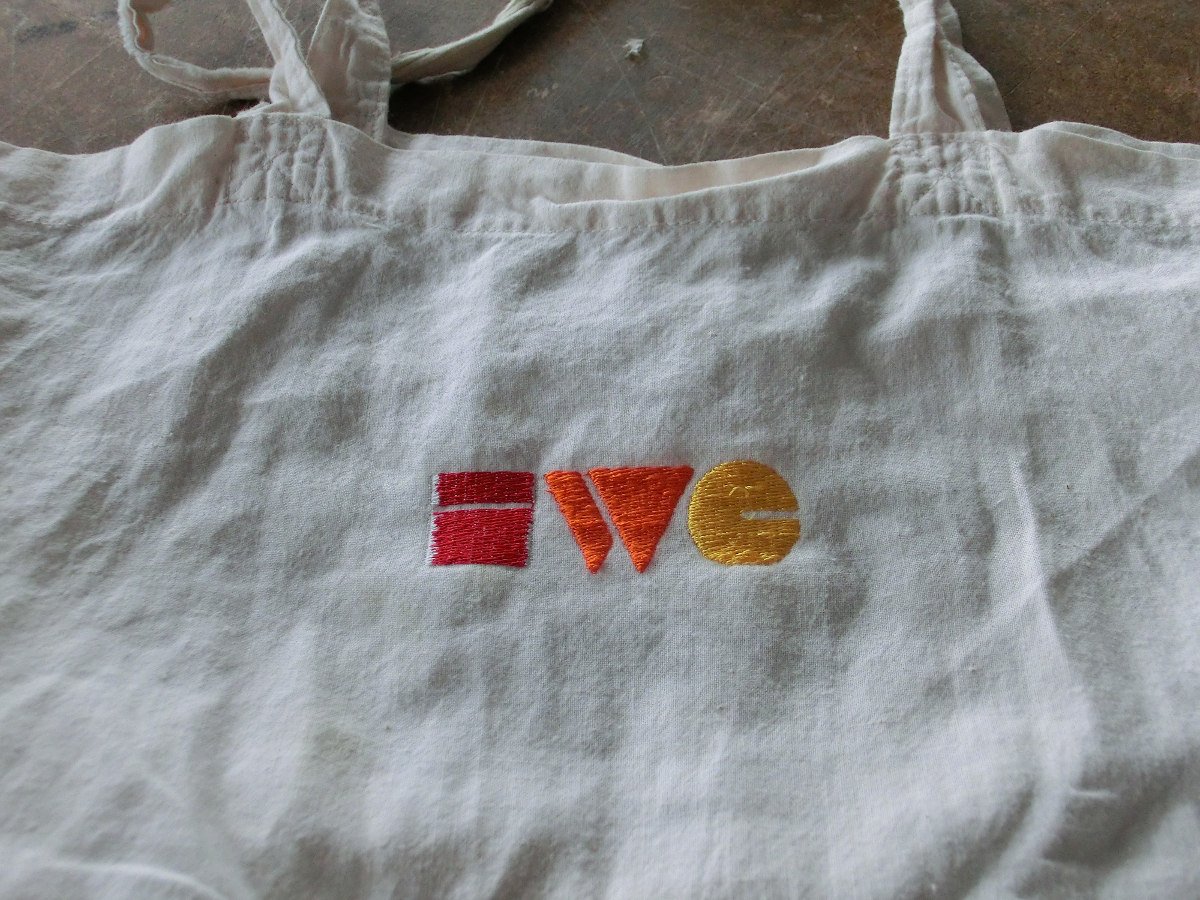 Photo of a linen handbag with the IndieWebCamp logo sewn into it