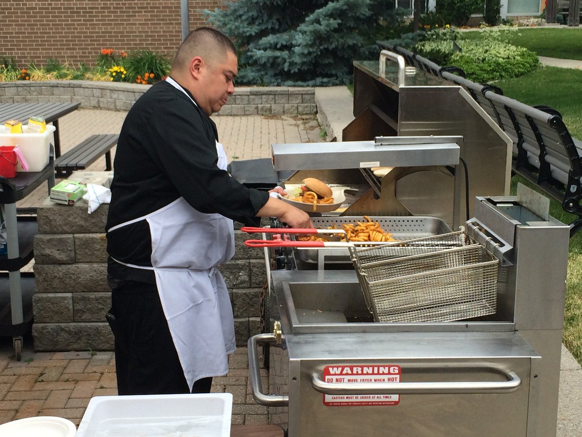 SjuCaf's tweet photo. Enjoy the wonderful weather with our outdoor grill. Diego is grilling up burgers #summer https://t.co/cPEjYURzzZ