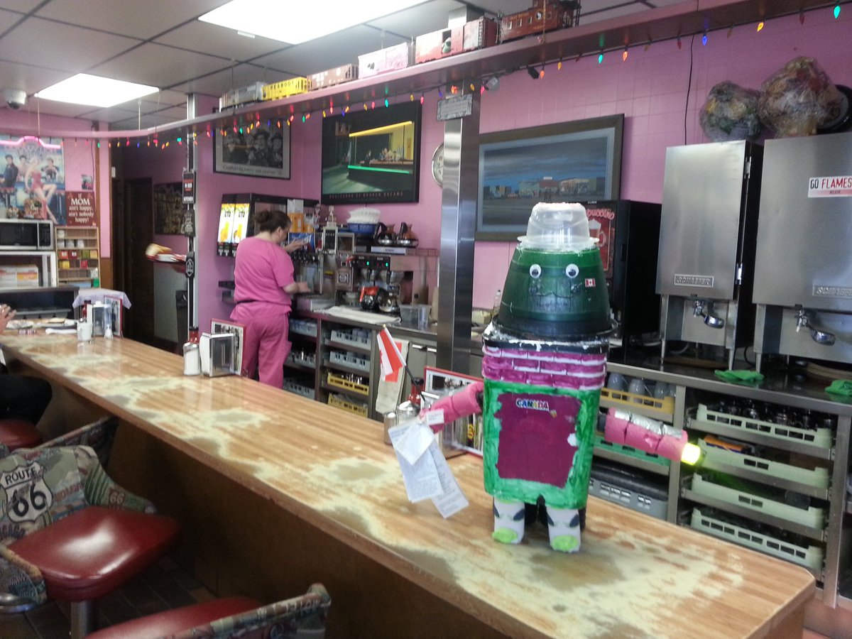 PeiganJan's tweet photo. @HitchbotWoods Henry the Hitchbot here!  Enjoyed a pitstop before hitting the road.  Hoping to hitch a ride east! https://t.co/yavEHM28Hd