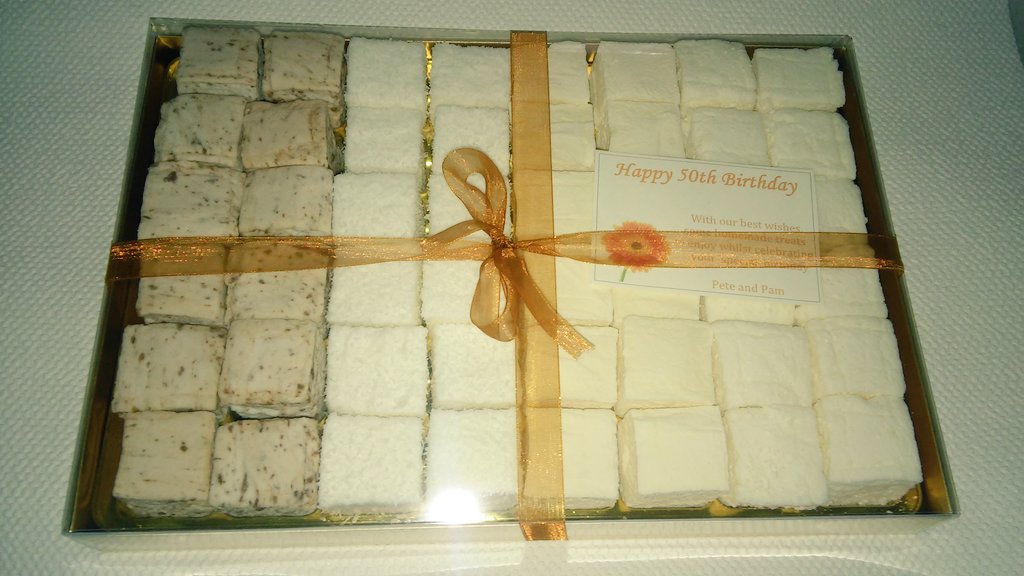 A 50th birthday party box order , with chocolate, coconut, mango and passion fruit and lemon meringue!