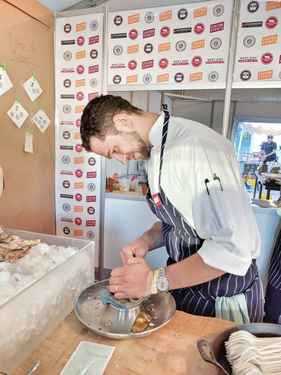 Chef Carl Heinrich shucking oysters at Taste of Toronto for Richmond Station