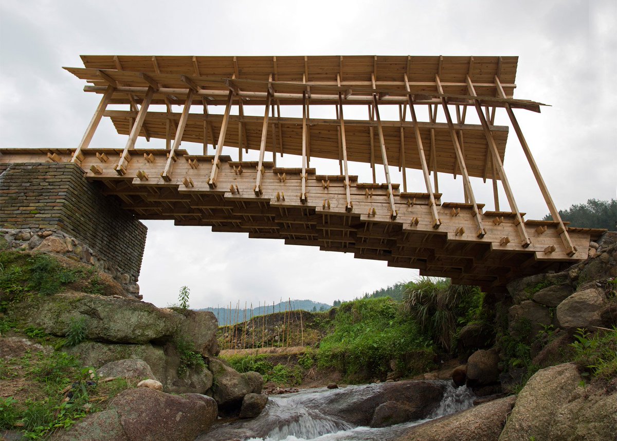 Huge timber steps form bridge built by students across a river in rural China: dezeen.com/?p=929269