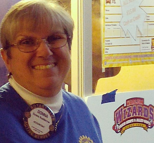 Rotarian Donna Rudderow welcomes fans to Harlem Wizards game