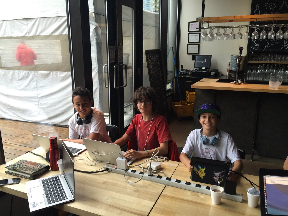 Our youngest hackathon kids, Spiro, Vito and Aris. Teaching each other Python.