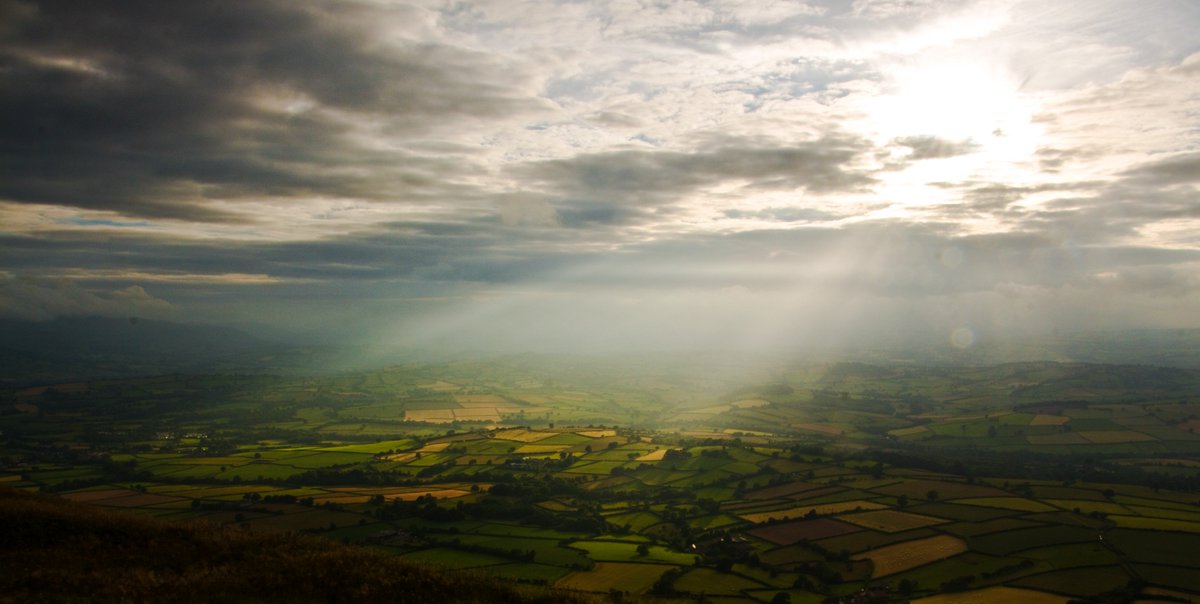 Sun beams burst across Llangorse fields. <a href="/visitwales/">Visit Wales 🏴󠁧󠁢󠁷󠁬󠁳󠁿</a> <a href="/breconbeaconsNP/">Alan</a> <a href="/midwalesmyway/">Mid Wales My Way</a> <a href="/itsyourwales/">It's Your Wales</a>