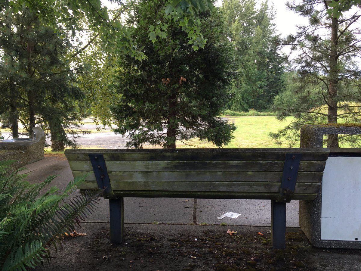 benchesofissy's tweet image. Bent, mossy bench with view of soccer field parking. Broken water fountain. Sheltered from bustle of 56th &amp;amp; SR900.