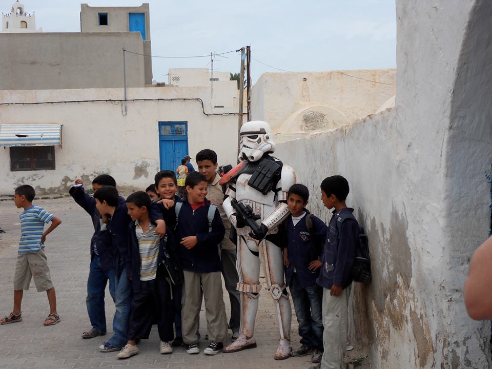 501SCG's tweet image. TT: TD-6682, hanging with some kids in Tunisia, Africa in front of "Blast Off Alley" @501stLegion #SoCalGarrison