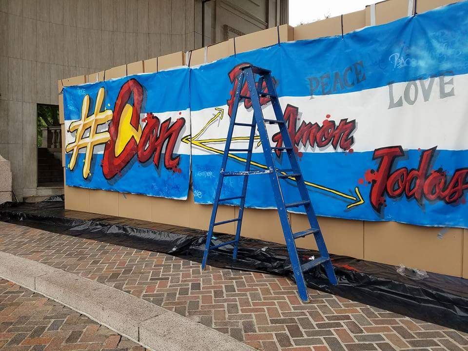 jde961's tweet image. Denver Civic Center. #ProgressNow builds compassionate 9' Wall #ConAmor (with 💛)  while trump speaks hate @ #WCS16