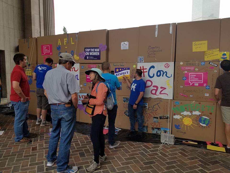 jde961's tweet image. Denver Civic Center. #ProgressNow builds compassionate 9' Wall #ConAmor (with 💛)  while trump speaks hate @ #WCS16