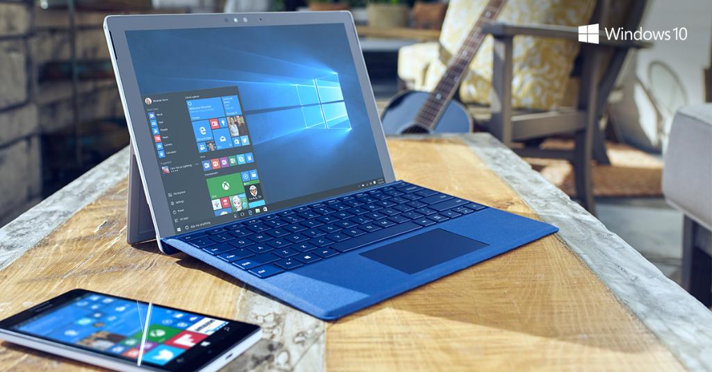 Surface with blue keyboard and Lumia on drafting table.