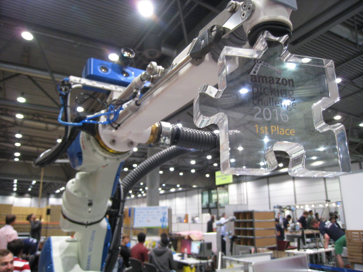 And of course, the robot arm from <a href="/teamdelft_apc/">Team Delft</a> gets to play with the award as well. Winner of the <a href="/AmazonPickChal/">AMZN Pick Challenge</a>!